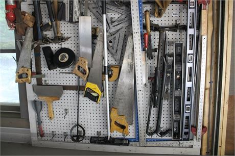 Assorted Hand Tools and Measuring Instruments on Pegboard